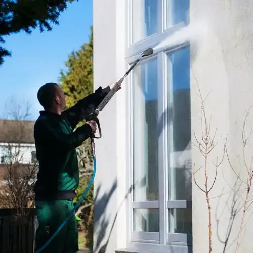 Professionell fasadtvätt med hetvatten på kommersiell fastighet
